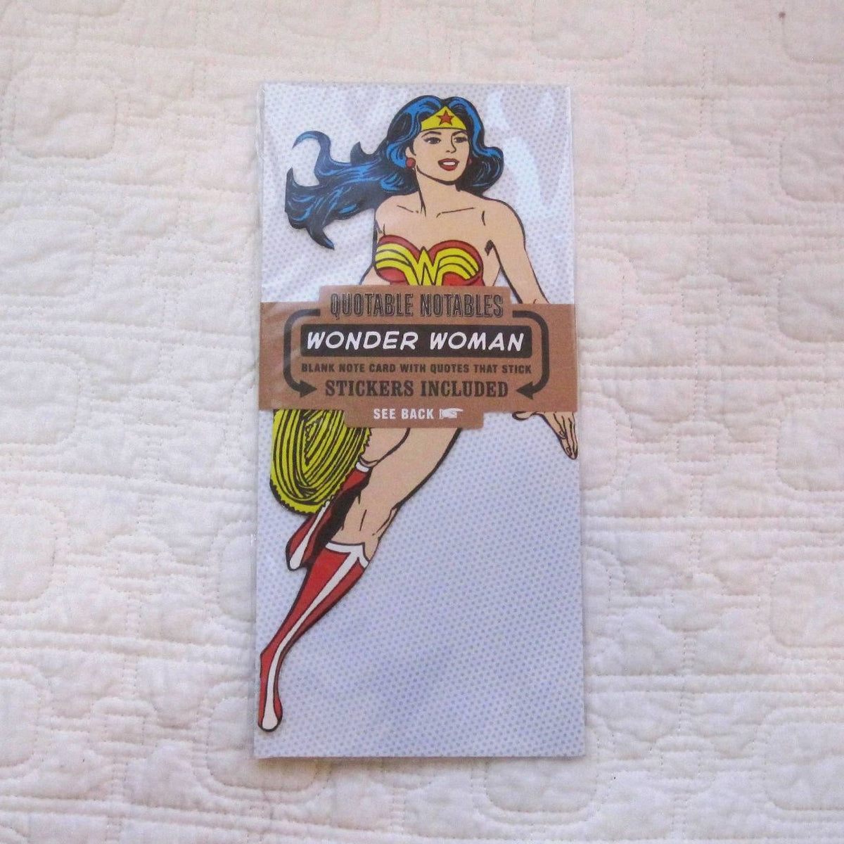 A game card of wonder woman with decorated borders and icons, in